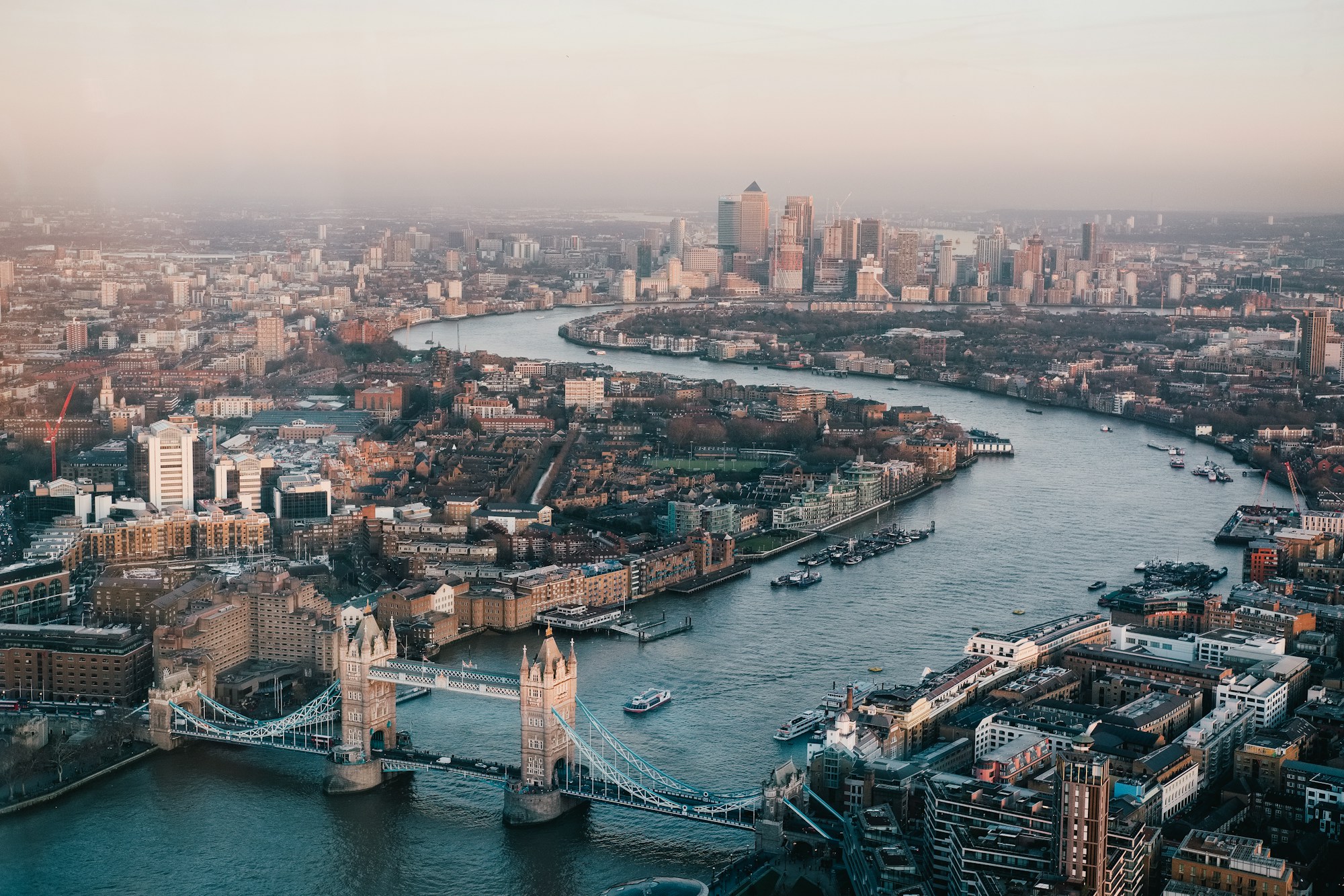 Tower Bridge and the Thames at dusk, looking toward Canary Wharf