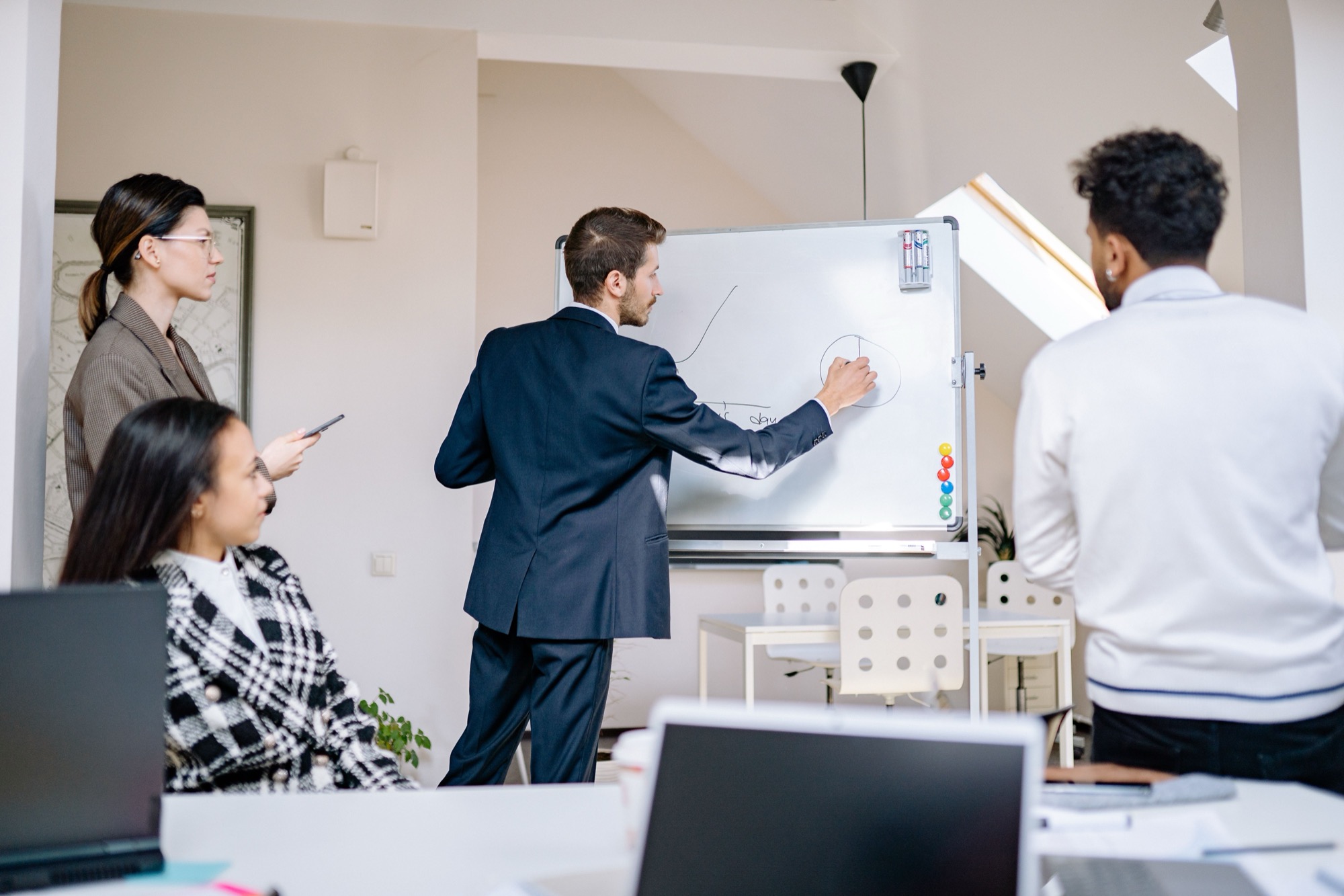 Team at a whiteboard mapping a system